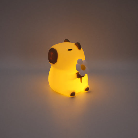 Glowing capybara night light on a grey background