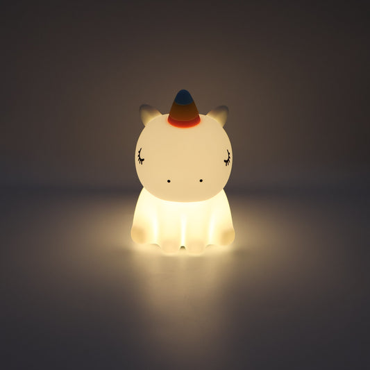 Glowing unicorn night light on a dark background