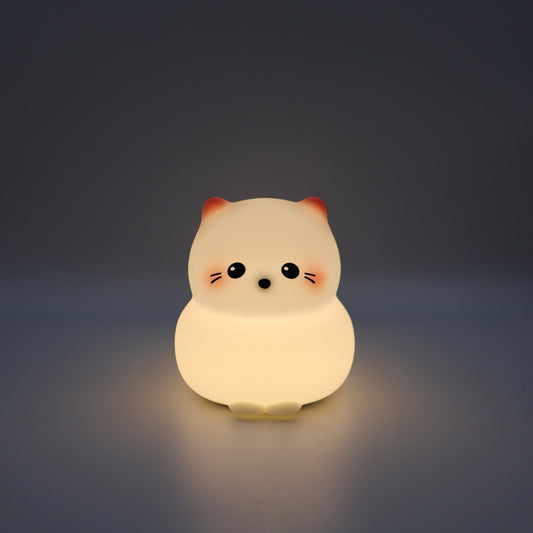 Glowing kitty night light on a dark background