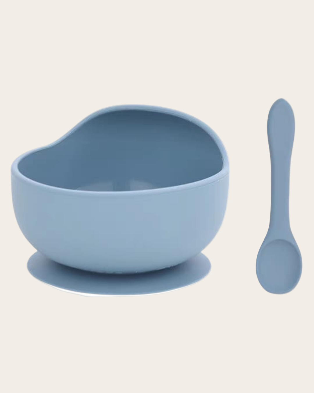 Blue bowl with suction base and matching spoon on a light gray background