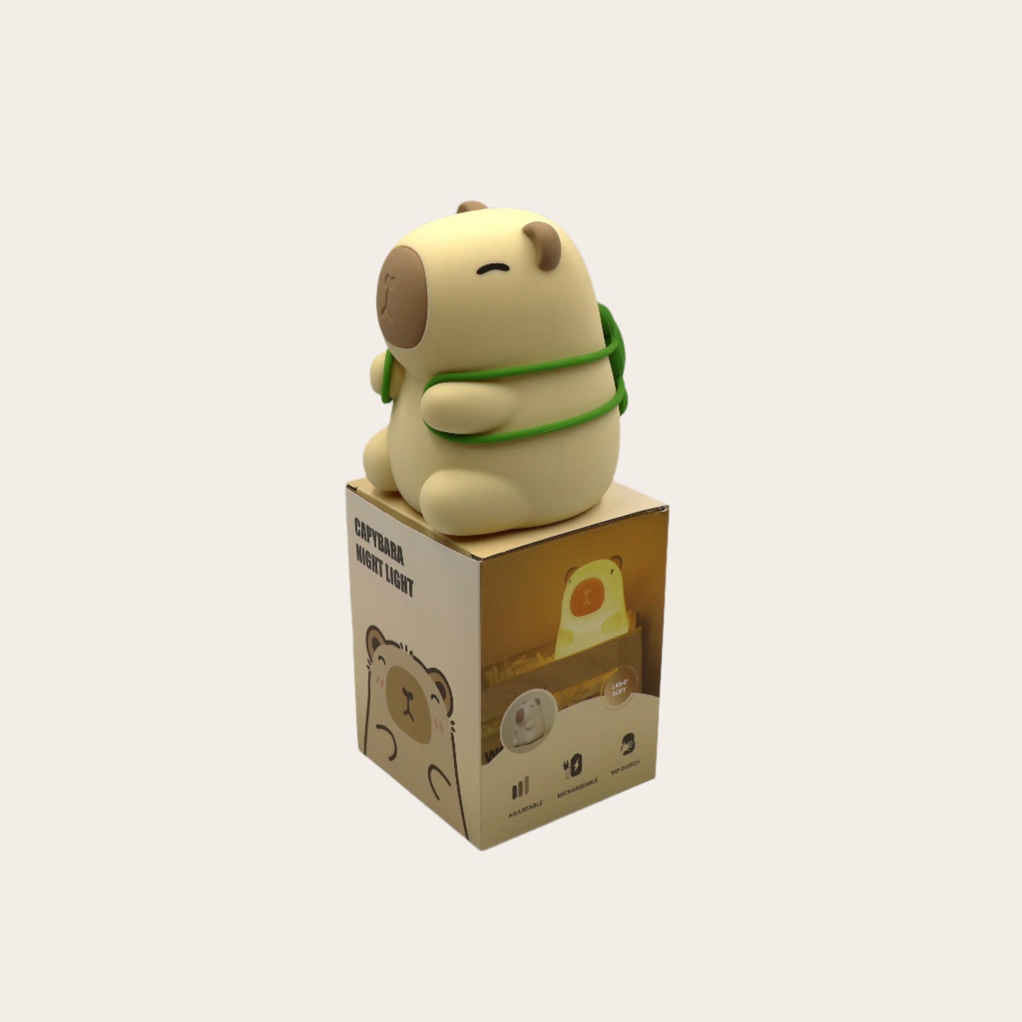 Capybara night light with a tortoise on its back, on a cardboard box against a white background
