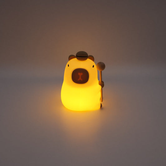 Glowing capybara night light on a grey background