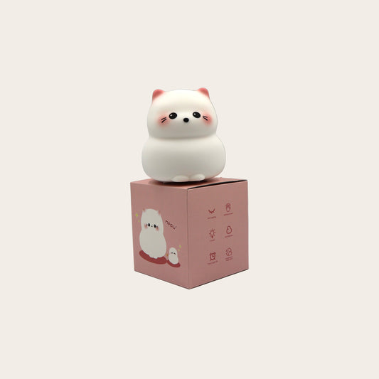White kitty night light on a pink box on a light gray background
