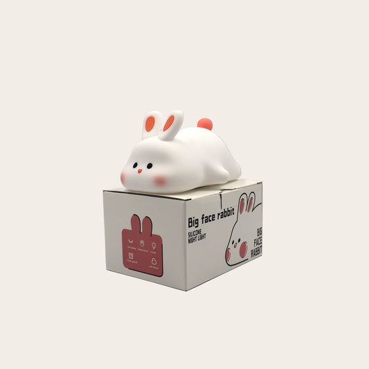 White rabbit night light on a box against a grey background